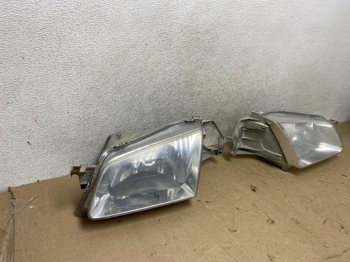 1999 to 2000 Mazda Protege Left+Right Side Headlights AH6890 DW1