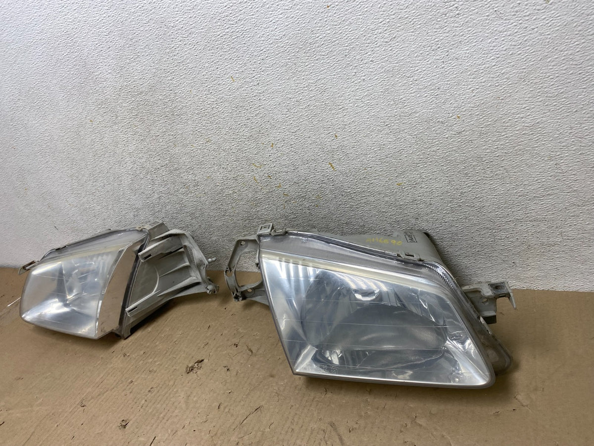 1999 to 2000 Mazda Protege Left+Right Side Headlights AH6890 DW2