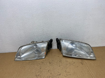2000 to 2002 Mazda 626 Left+Right Side Headlights AD1087 DW0