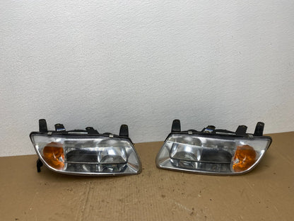 2000 to 2002 Saturn L Series Left+Right Set Halogen Headlights TYC AB6965 DW0