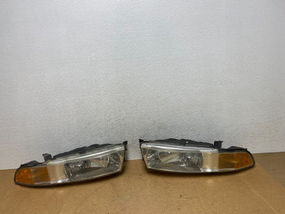 2002 to 2003 Mitsubishi Galant Left+Right Side Headlights AE3173 DW0