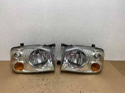 2001 to 2004 Nissan Frontier Left+Right Halogen Headlights AE6473 DW0