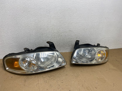 2004 - 2006 Nissan Sentra Halogen Left+Right Headlights AE9226 DW2
