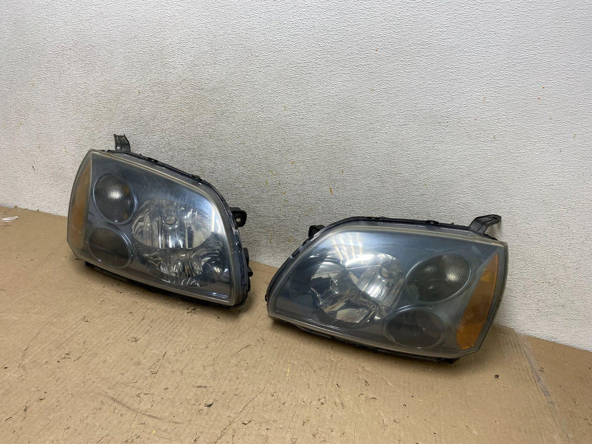 2004 to 2009 Mitsubishi Galant Left+Right Headlights Halogen AH7650 DW2