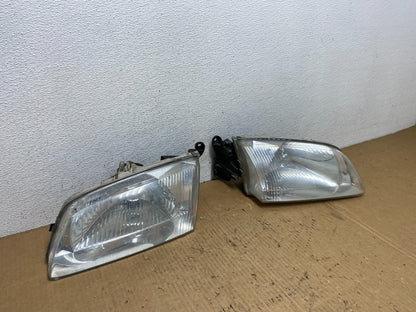 2000 to 2002 Mazda 626 Left+Right Side Headlights AD1087 DW2