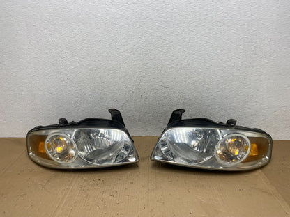 2004 - 2006 Nissan Sentra Halogen Left+Right Headlights AE9226 DW0