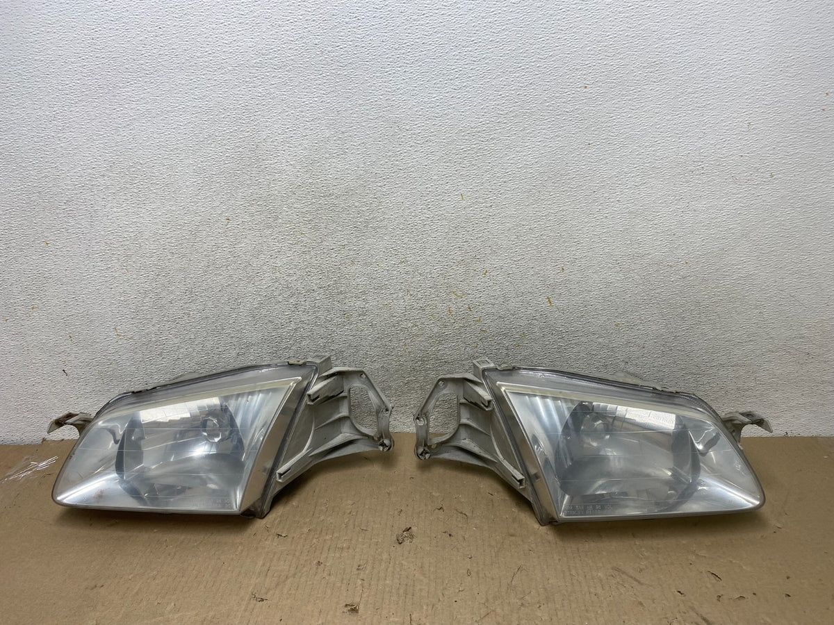 1999 to 2000 Mazda Protege Left+Right Side Headlights AH6890 DW0